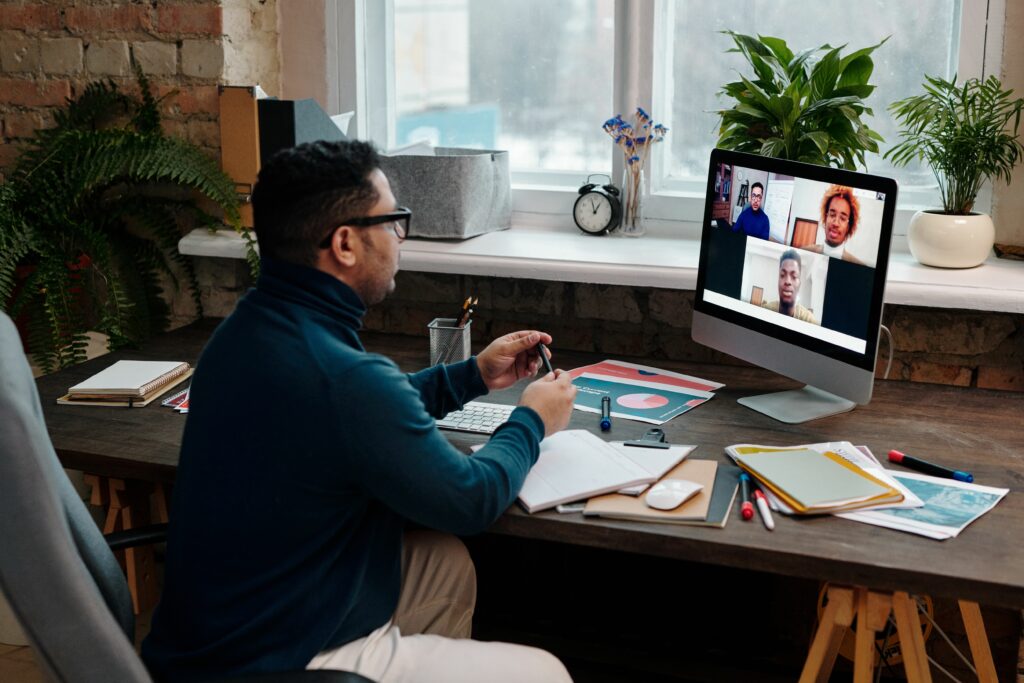teacher-video-calling-with-his-students-using-a-computer